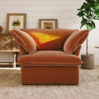 Dark orange armchair in a room with wooden floor and white walls