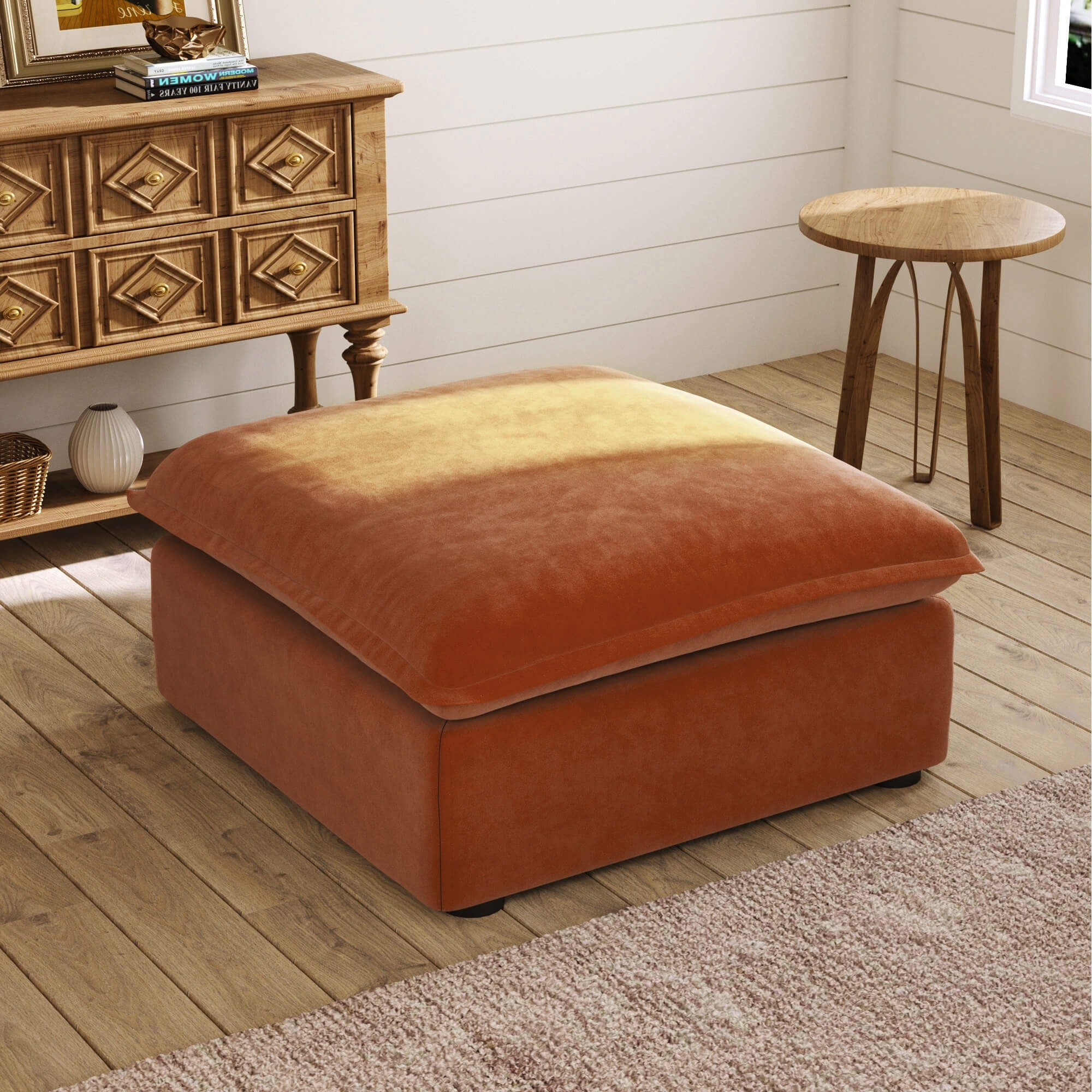 Dark orange ottoman in a room with wooden furniture and decor.