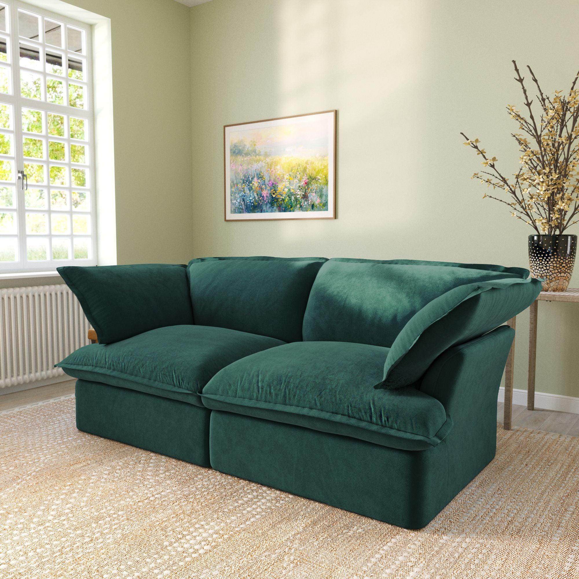 Modular velvet loveseat sofa with curved armrests in green, side