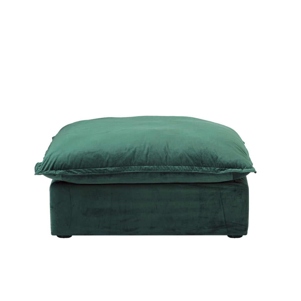 A green velvet pouf ottoman with plush upholstery, shown with a removable cover.