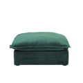 A green velvet pouf ottoman with plush upholstery, shown with a removable cover.