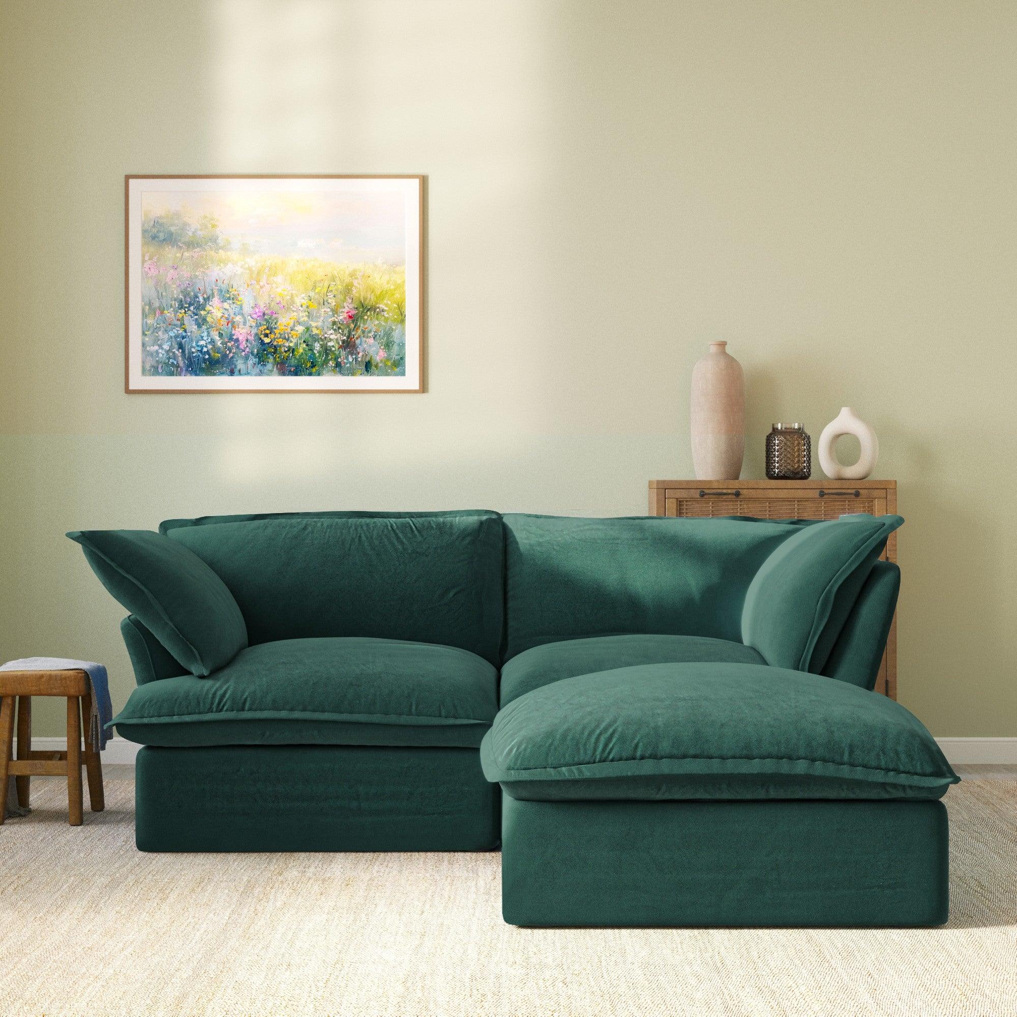 Modular velvet loveseat sofa with storage ottoman and curved armrests in green, front