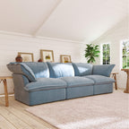 Light blue 3-seater sofa in a living room with wooden floor and white walls