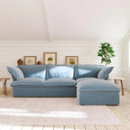Light blue L-shaped 4-seater sectional sofa in a living room with white walls and wooden floors.