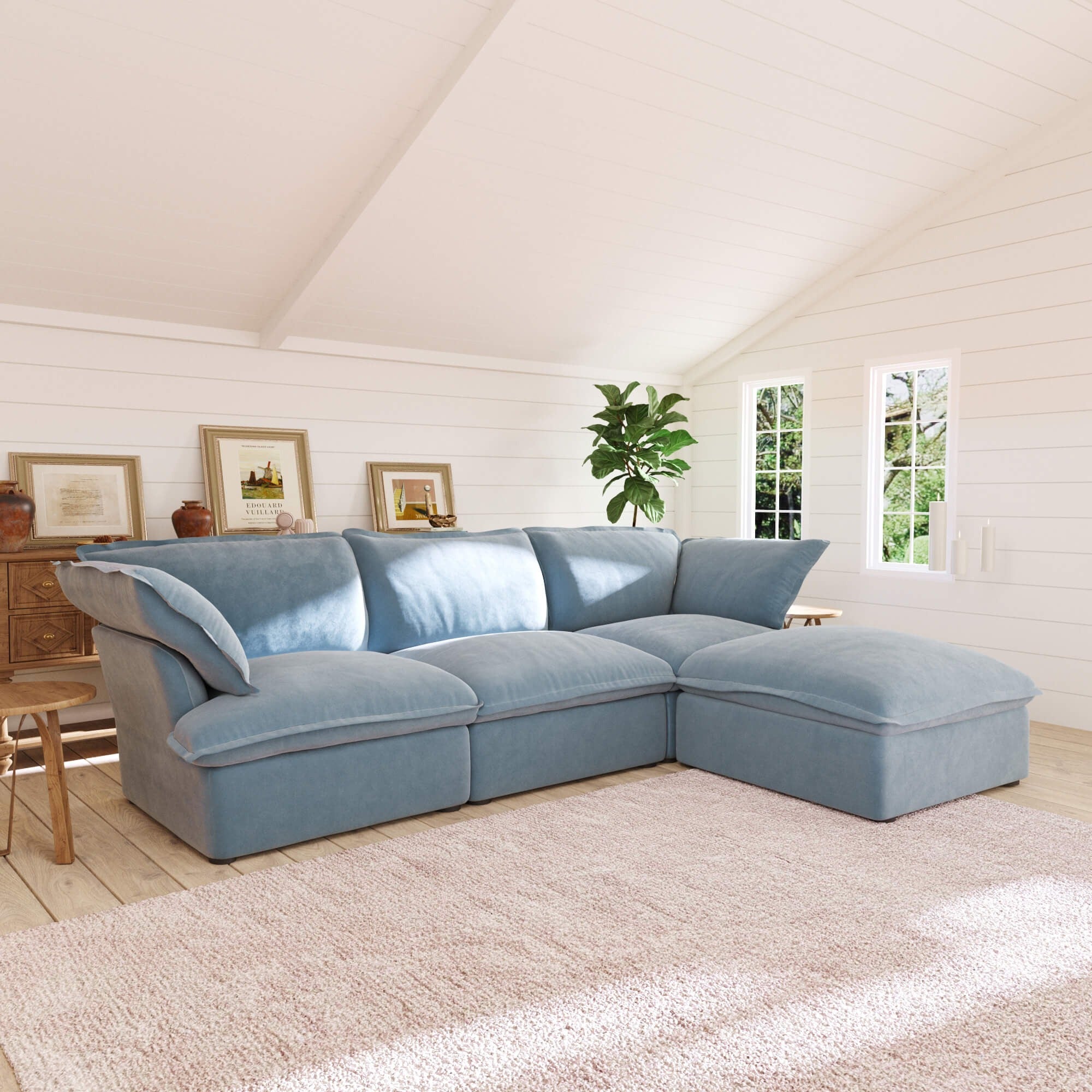 Light blue L-shaped 4-seater sectional sofa in a living room with white walls and wooden floors.