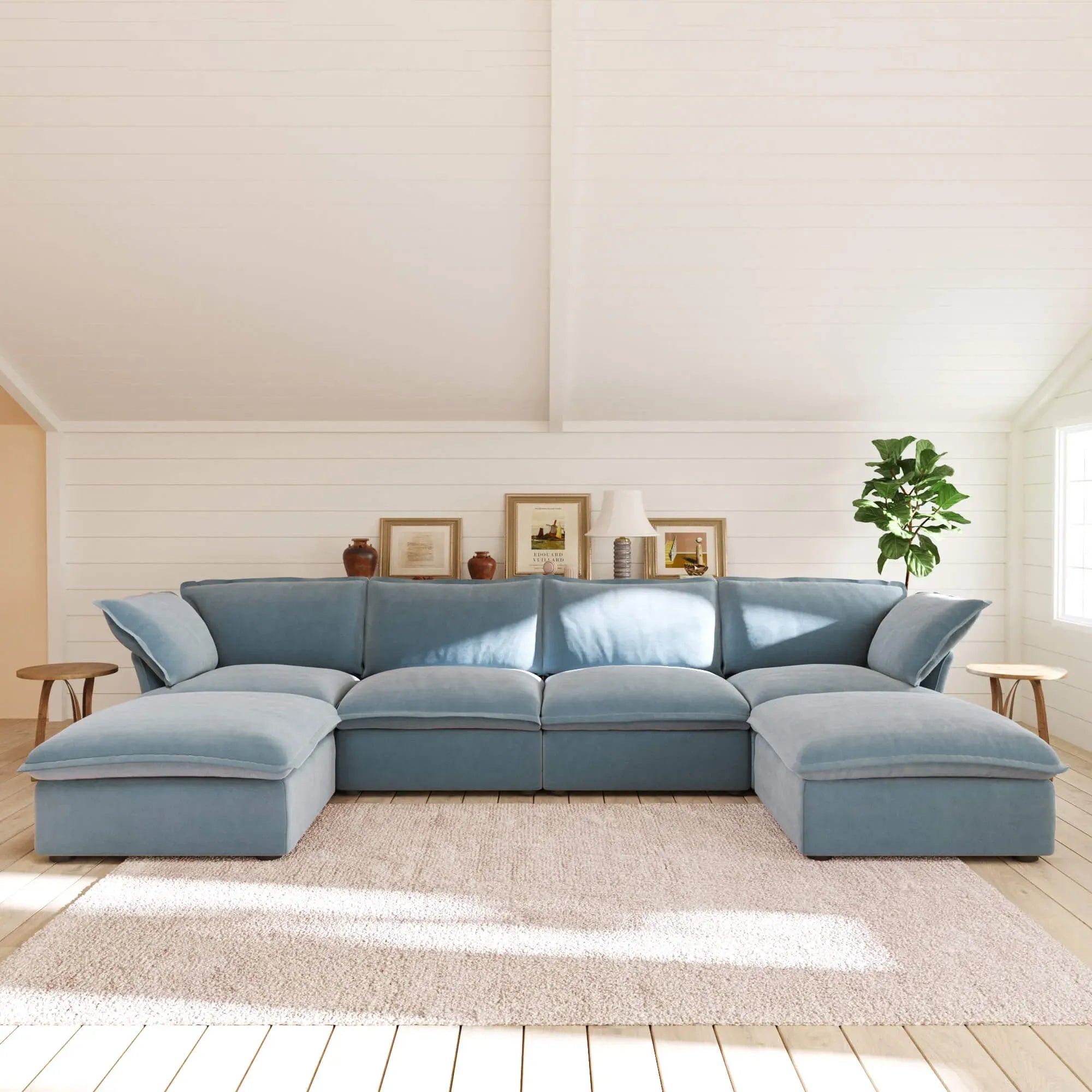Light blue U-shaped sectional sofa in a living room with decor elements.