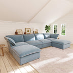 Light blue U-shaped sectional sofa in a bright living room with wooden floor and white walls.