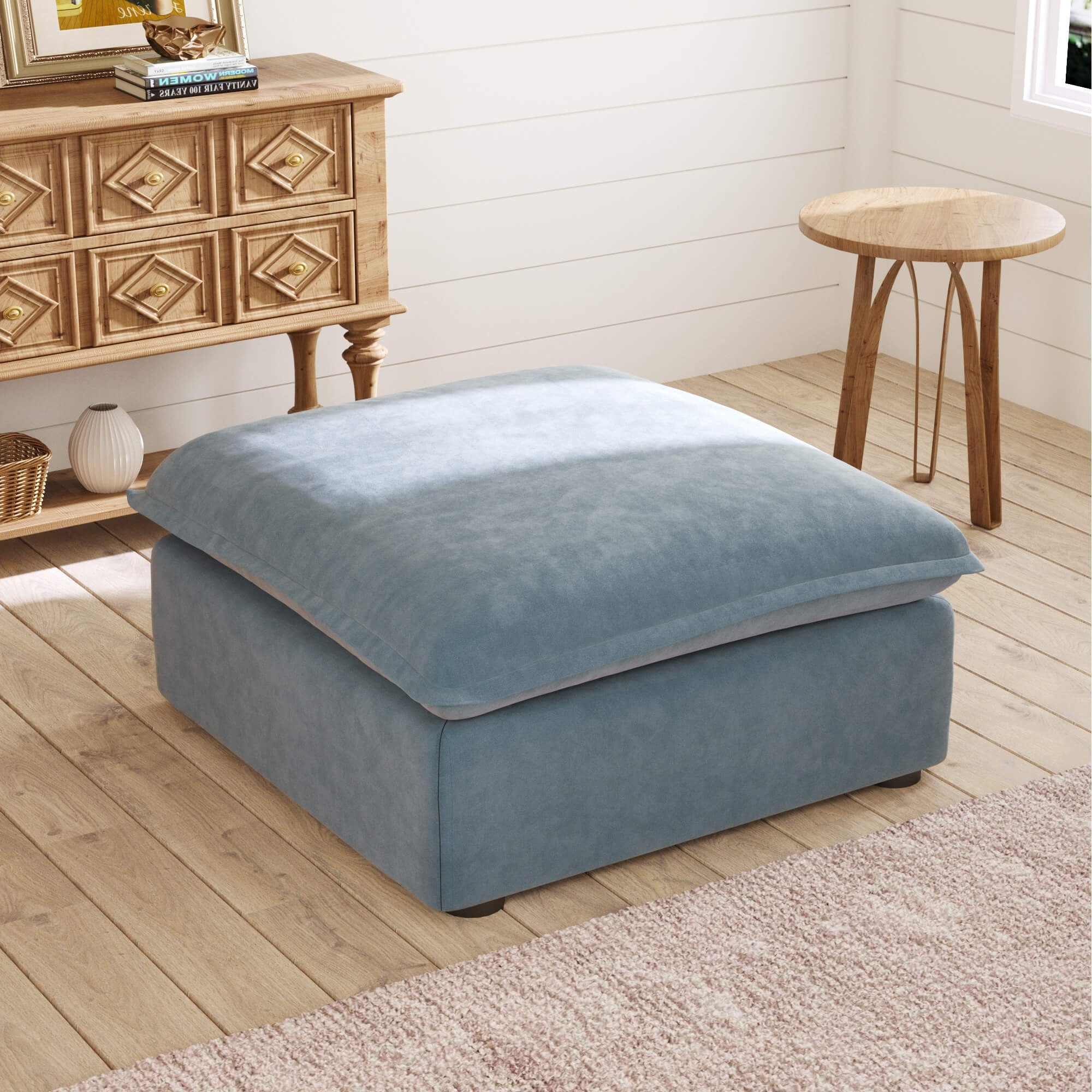 Light blue ottoman in a room with wooden furniture and decor.