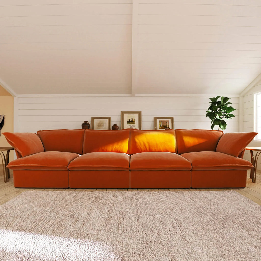 Orange sectional 4-seat sofa in a living room with a neutral color palette