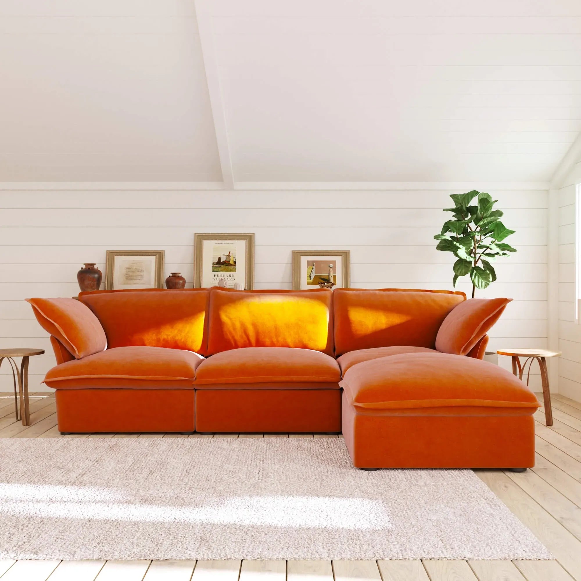 Orange L-shaped 4-seater sectional sofa in a living room with white walls and a plant.