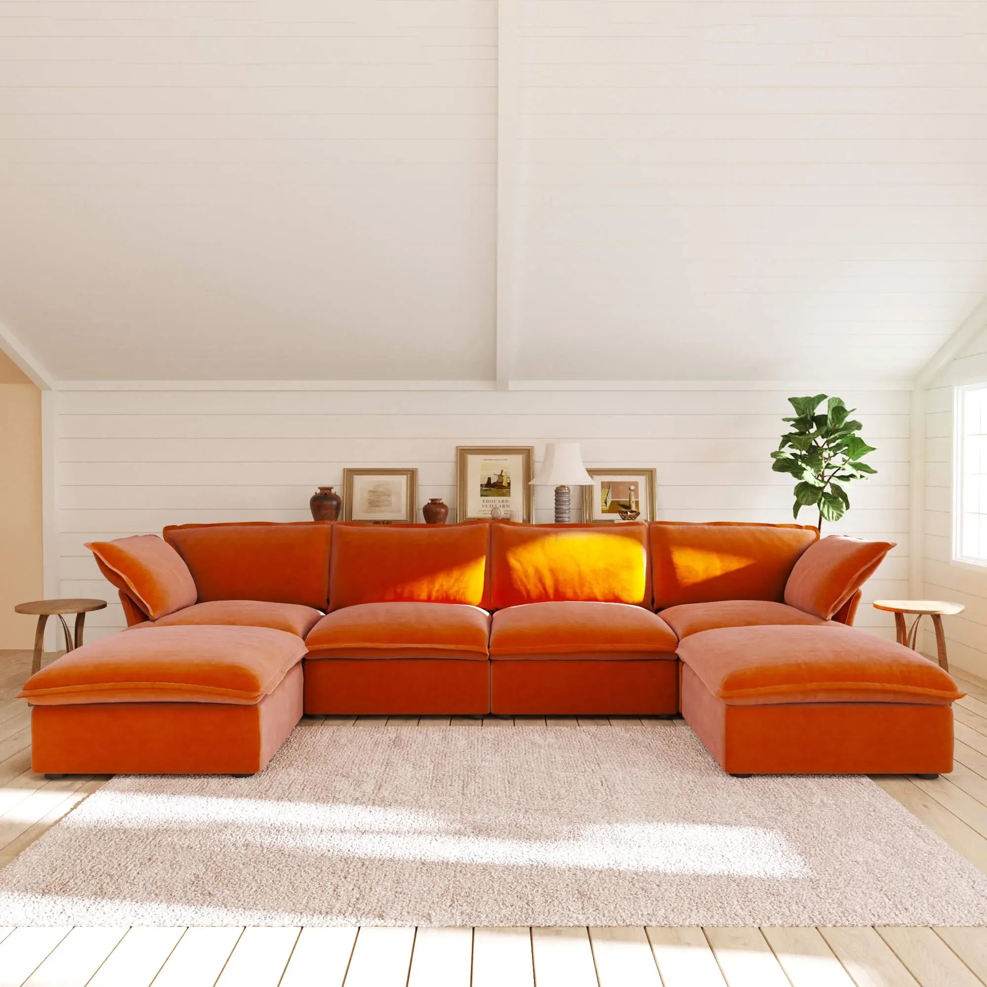 Orange U-shaped sectional sofa in a living room with a white wall and wooden floor.