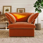 Orange armchair in a room with wooden floor and white walls