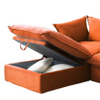 Close-up of an open storage ottoman with pillows inside of an orange sofa