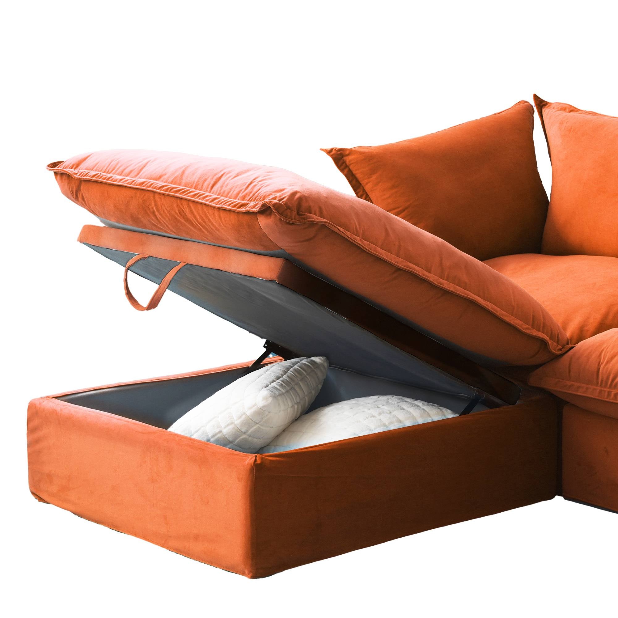 Close-up of an open storage ottoman with pillows inside of an orange sofa
