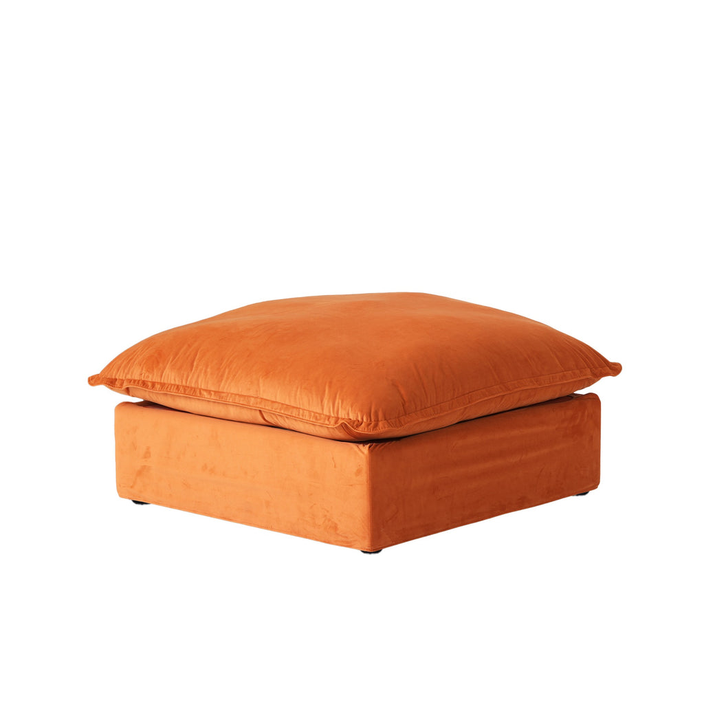Orange velvet ottoman with washable covers on a white background