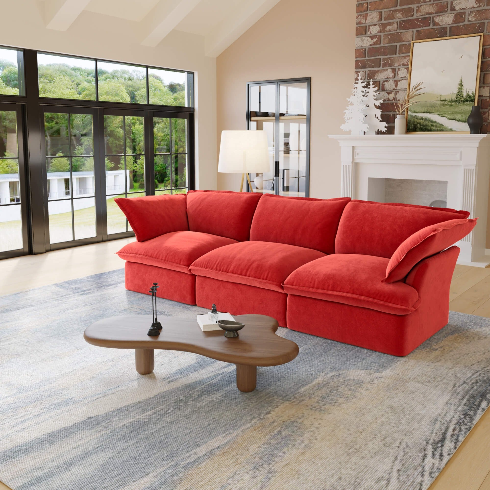 Red 3-seat sofa in a living room with large windows and a fireplace.
