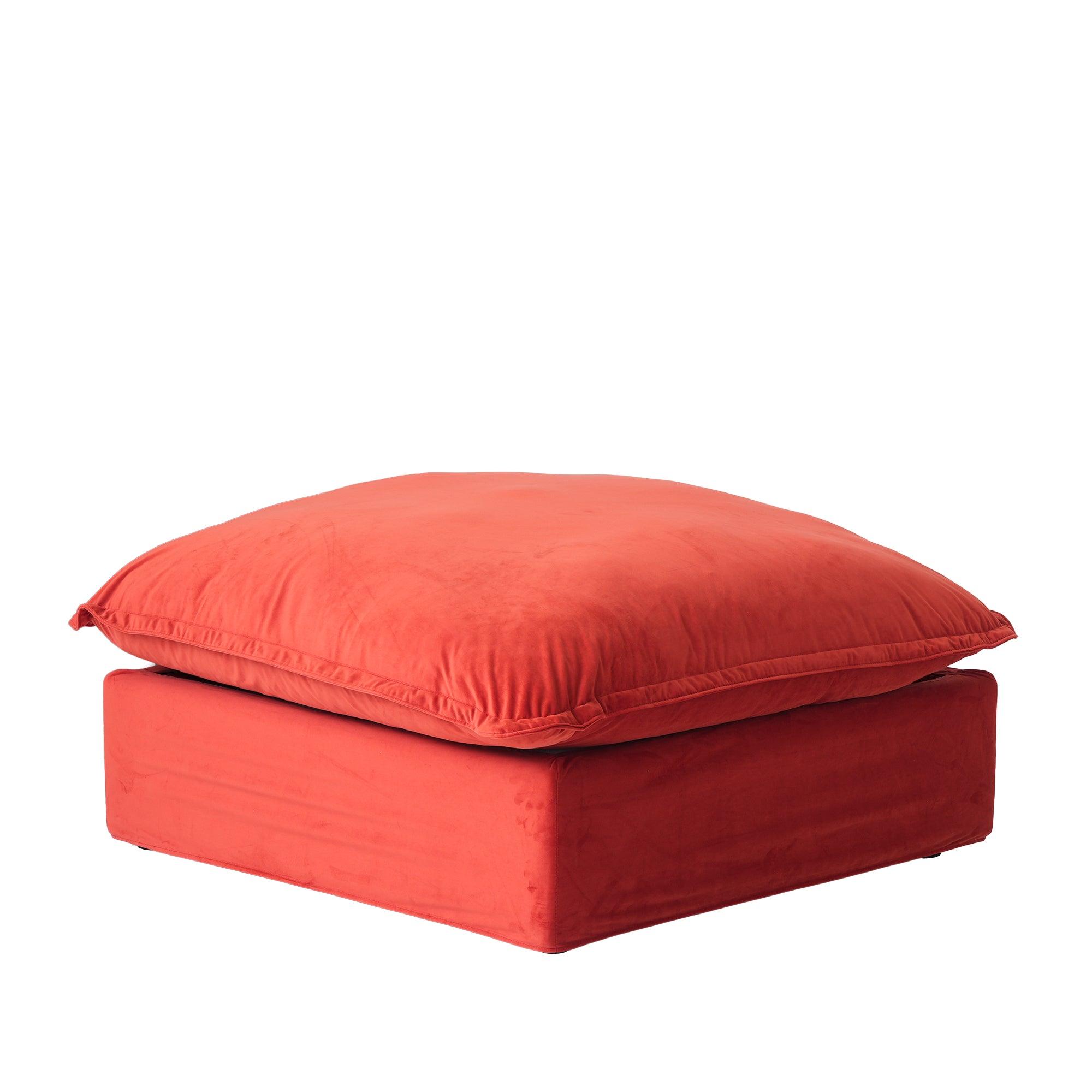A red velvet ottoman with a cushioned top, designed as a modular sectional sofa piece.