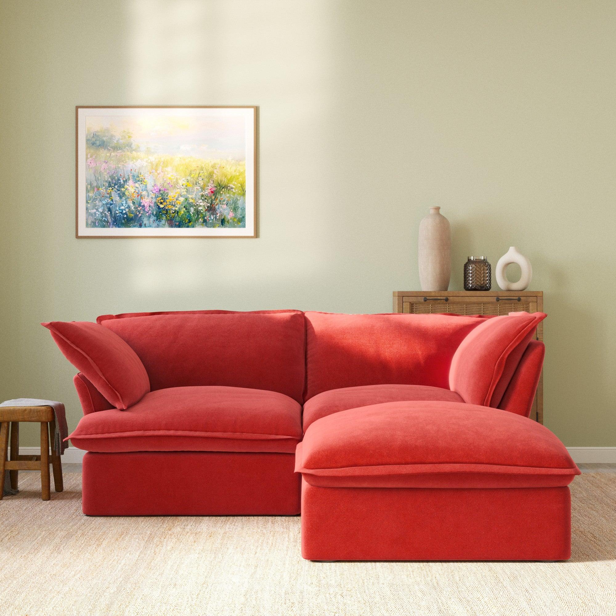 Modular velvet loveseat sofa with storage ottoman and curved armrests in red, front