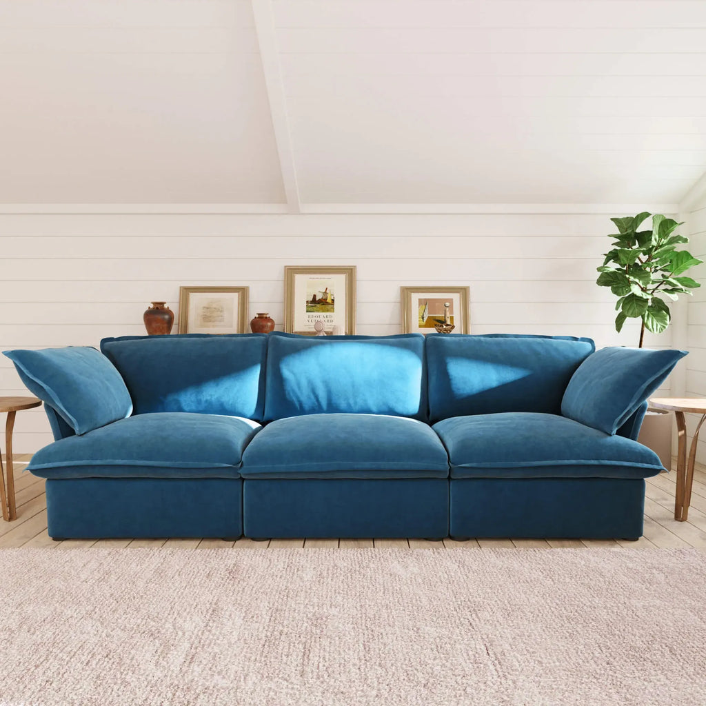 Sky blue 3-seat sofa in a living room with a neutral color palette