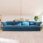 Sky blue 4-seat sofa in a living room with a white wall and decorative items.