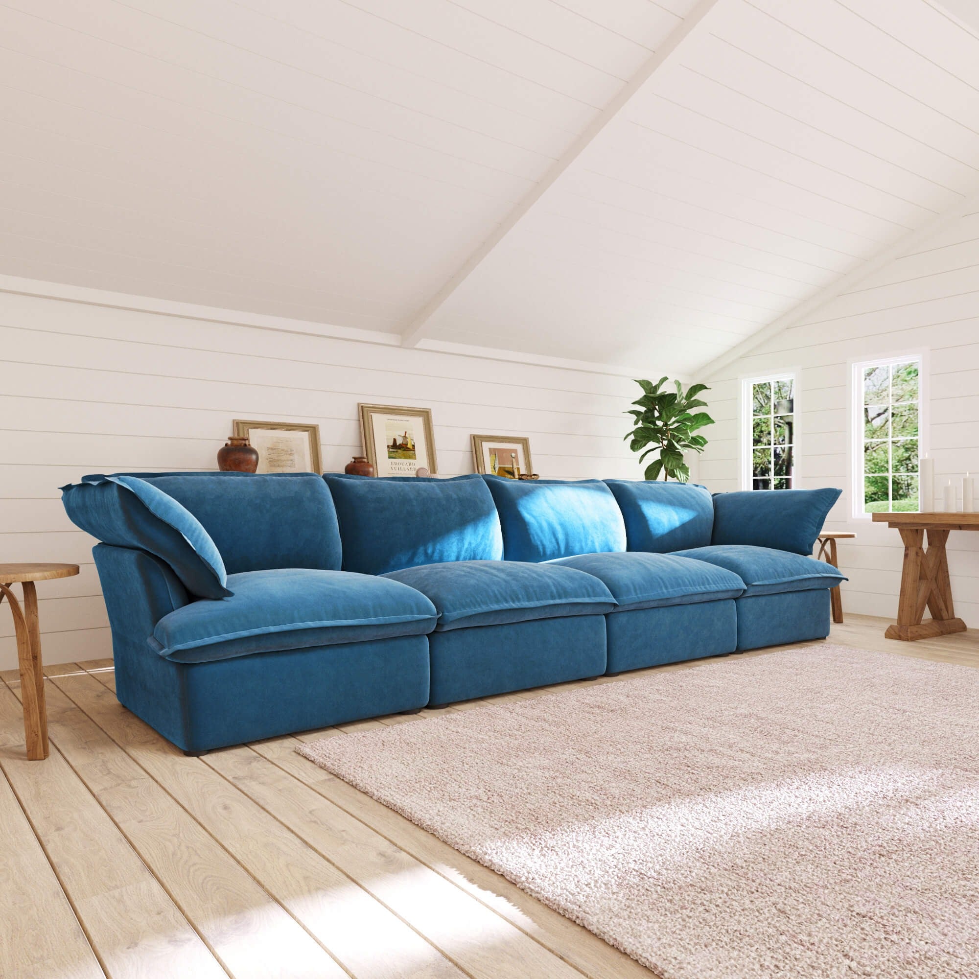 Sky blue 4-seat sectional sofa in a bright living room with wooden floors and white walls.