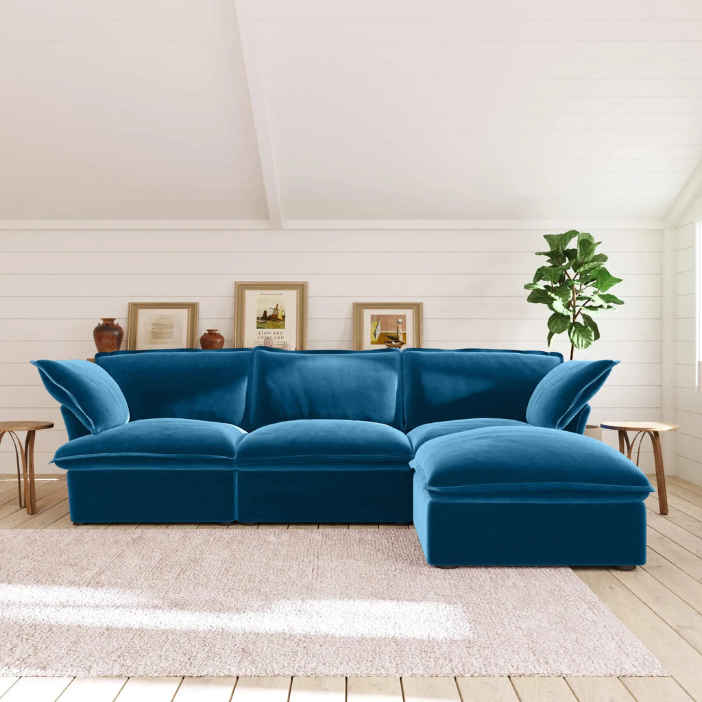 Sky blue L-shaped 4-seater sectional sofa in a living room with white walls and wooden floors.