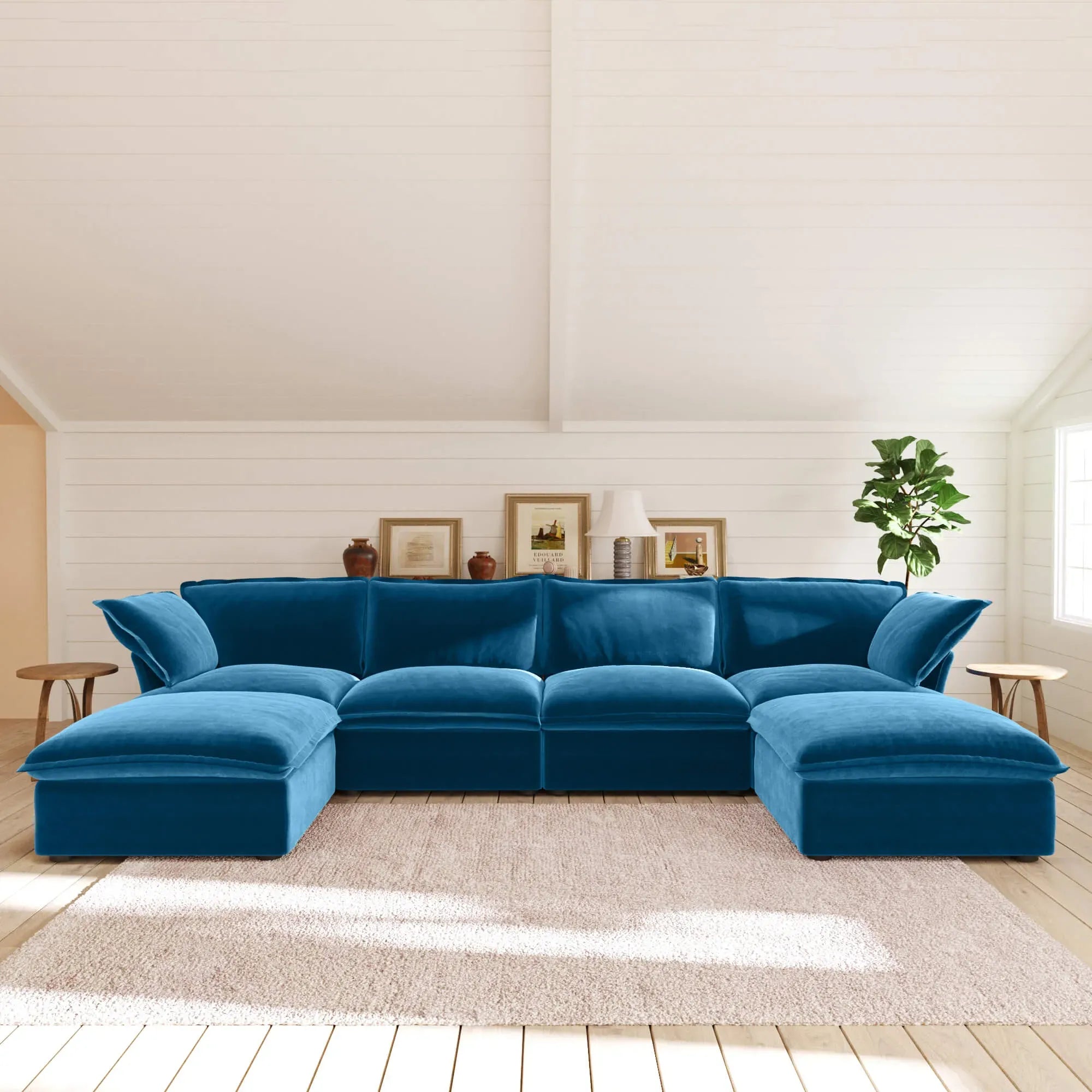 Sky blue U-shaped sectional sofa in a living room with white walls and wooden floor.