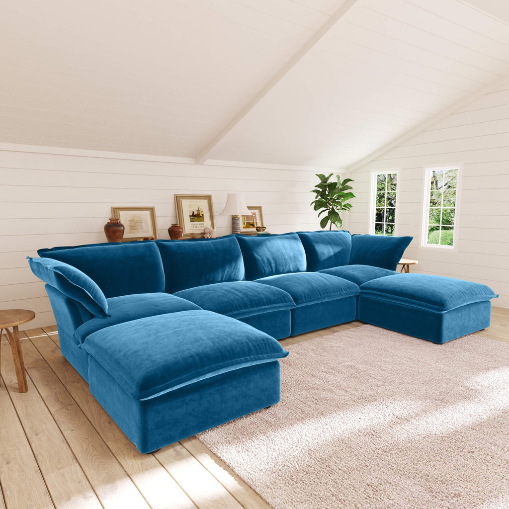 Sky blue U-shaped sectional sofa in a living room with wooden floor and white walls