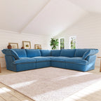 Sky blue corner sectional sofa in a living room with a white wall and window.