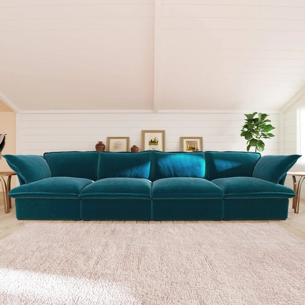 Turquoise 4-seat sectional sofa in a room with wooden floor and white walls