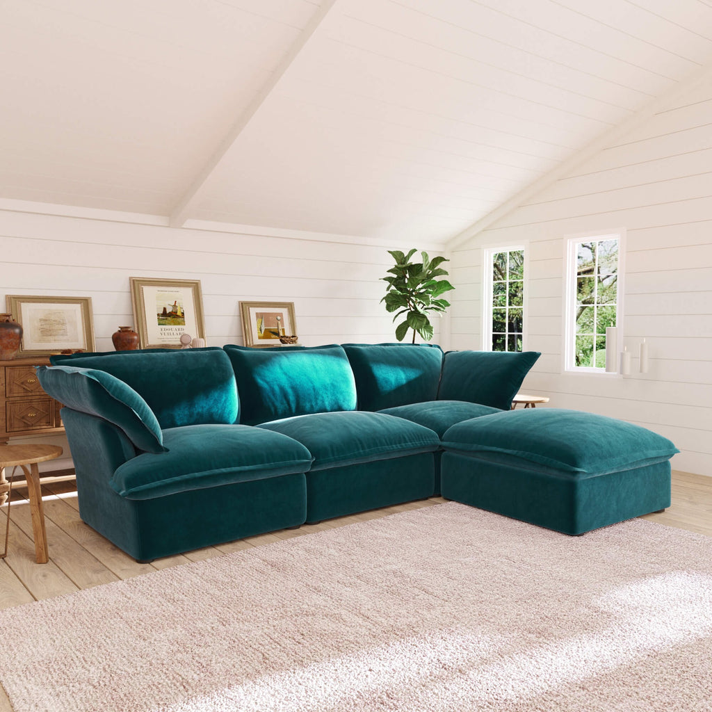 Turquoise L-shaped 4-seater sectional sofa in a living room with white walls and wooden floor.
