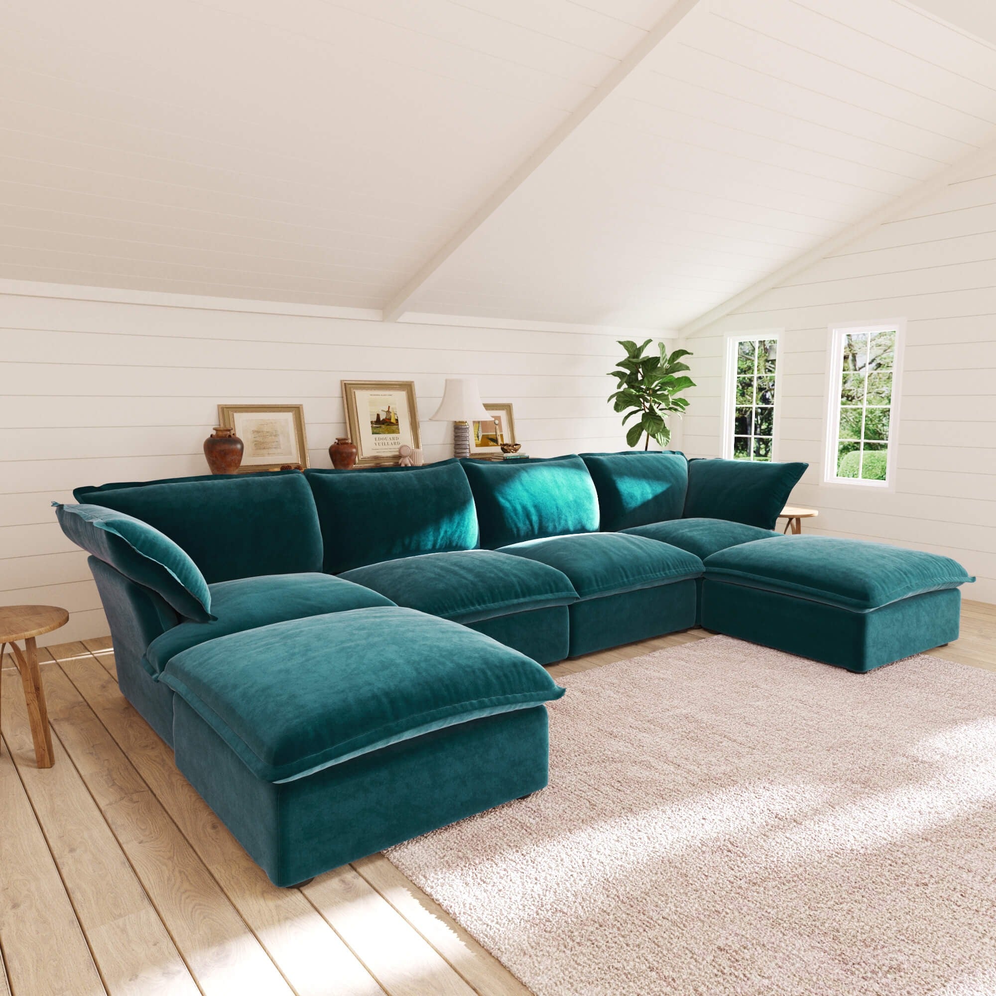 Teal U-shaped sectional sofa in a living room with wooden floor and white walls