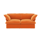 Orange velvet sofa with flared armrests on a white background