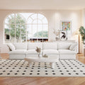 A white linen 4-seat sectional sofa arranged in a living room setting with deep seating.