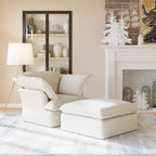 White armchair and ottoman in a living room with a fireplace and decorative mirror.