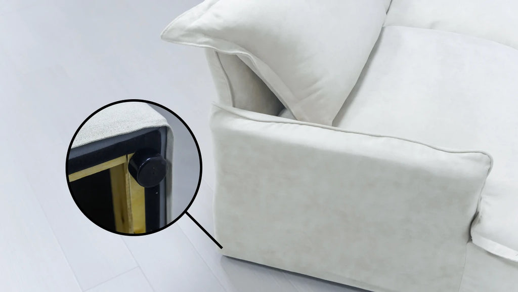 Close-up of a leg of a white sofa