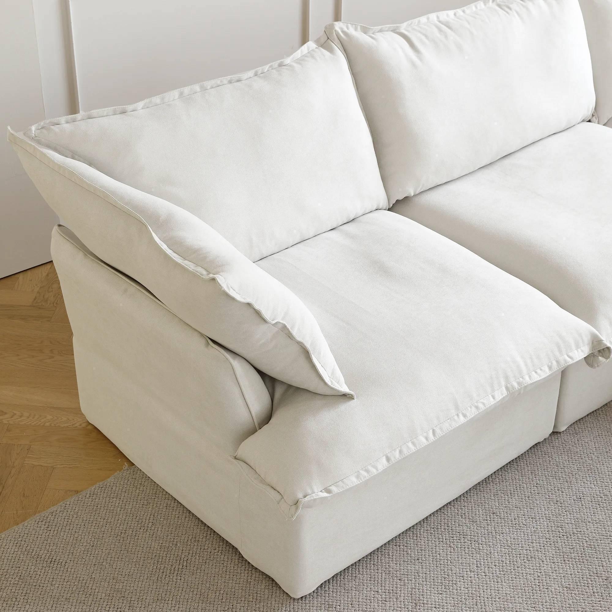 Armrest seat of a white sectional linen sofa