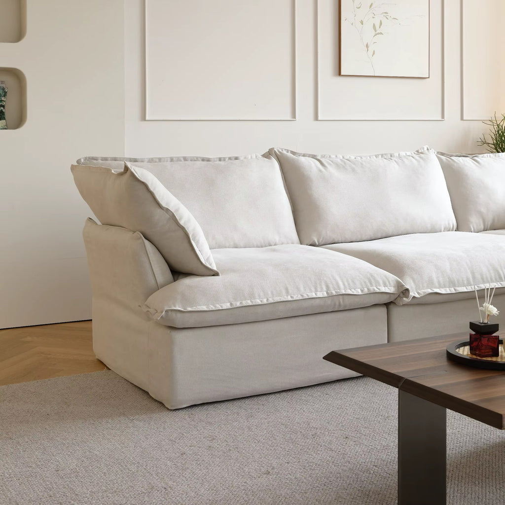 White sofa in a living room with a wooden coffee table and decorative items.