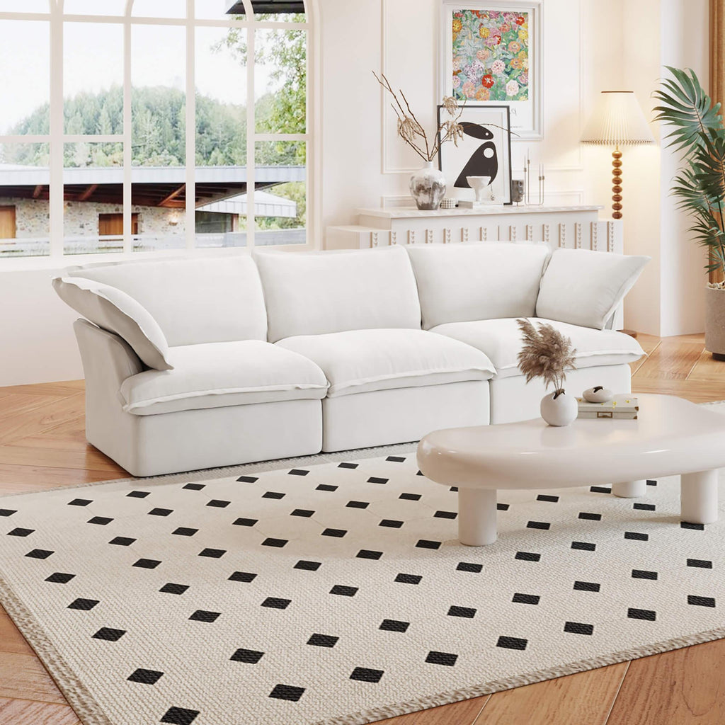 A white 3-seater linen sectional sofa in a modern living room setting with deep seating.