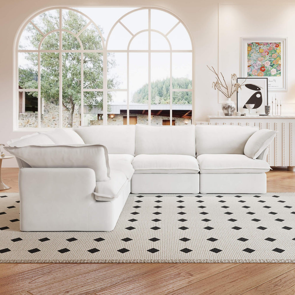 A white 5-piece corner linen sectional sofa arranged in a living room setting with a patterned rug on the floor.