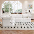 A white 5-piece corner linen sectional sofa arranged in a living room setting with a patterned rug on the floor.