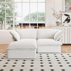 A white chaise lounge loveseat linen sectional sofa with a modular design and a storage ottoman, placed on a patterned rug in a bright living space.
