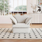 A white linen armchair with a solid frame and washable covers, placed on a patterned rug in a bright room.