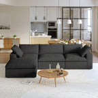 A black L-shaped modular sectional sofa with a storage ottoman in a modern living room setting.