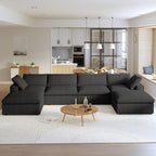A large, U-shaped, black modular sectional sofa with storage ottoman in a modern living room setting.