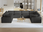 A modern, modular pit-style 8-seat sectional sofa in black in a living room setting with white cushions and a clean, contemporary design.