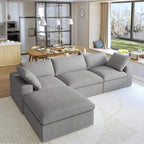 A gray L-shaped modular sectional sofa with a storage ottoman in a modern living room setting.