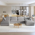 A large, U-shaped, gray modular sectional sofa with storage ottoman in a modern living room setting.