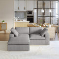 A gray modular sectional sofa with a storage ottoman in a modern living room setting.
