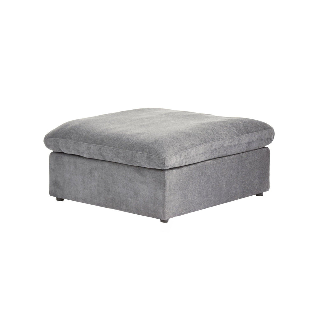 A gray linen upholstered ottoman with a cushioned top.